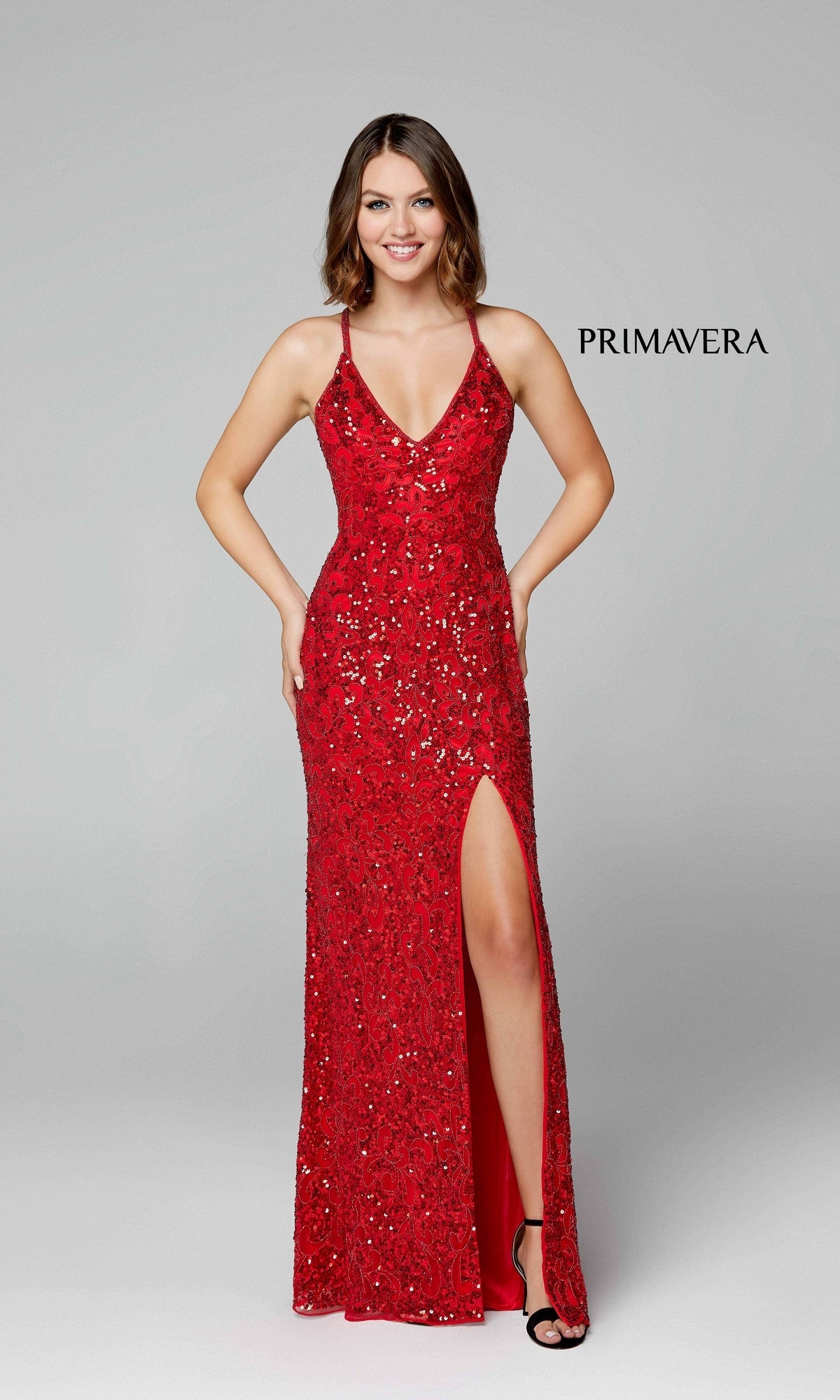 A woman poses against a plain light background in the Dark Sequin-Pattern Long Prom Dress 3295D, a sleeveless, floor-length gown with a thigh-high slit. The word